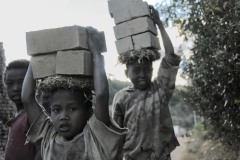 Madagascar, children carrying bricks