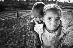 Madagascar, girl carrying baby