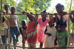 Haiti, children behind fence