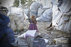 Haiti, girl between huge bags