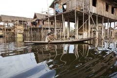 Myanmar, lake Inle, boat in front of pile buildings