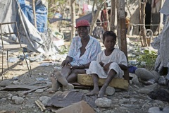 Haiti, old woman and girl in tent village