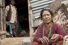 Nepal, old couple in front of destroyed house