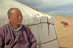 Mongolian nomad in front of yurt